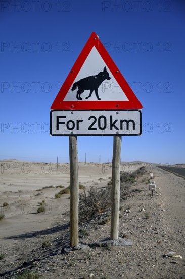 Sign warning of brown hyenas or beach wolves (Parahyaena brunnea), near Lüderitz, Karas Region, Namibia