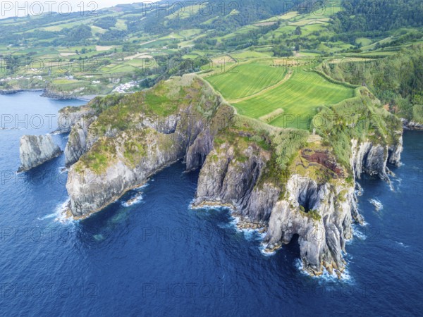 Cape Furado, Rocky Cliffs, Green Lush Fields, Pasturelands, Hills and Atlantic Ocean. Azores, Sao Miguel Island. Portugal. Aerial View