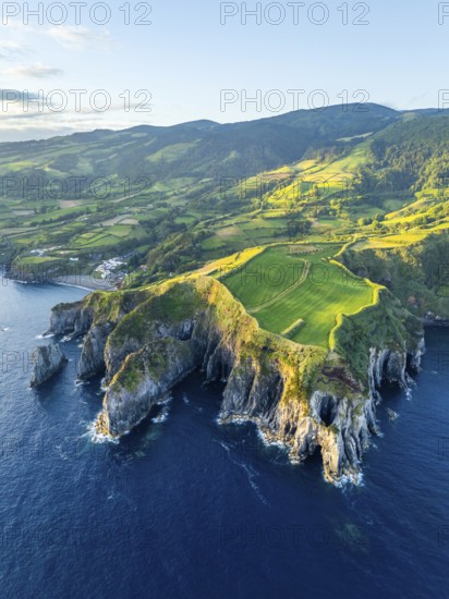 Cape Furado, Rocky Cliffs, Hills, Green Lush Fields, Pasturelands and Atlantic Ocean at Sunrise. Azores, Sao Miguel Island. Portugal. Aerial View