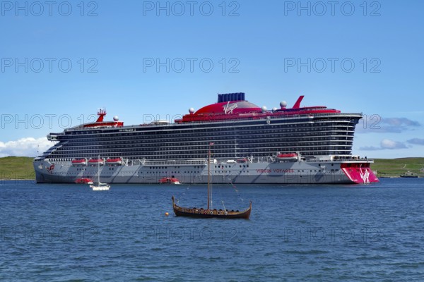 Large cruise ship next to a small Viking boat at sea, overtourism, Lerwick, Shetland Islands, Scotland, United Kingdom