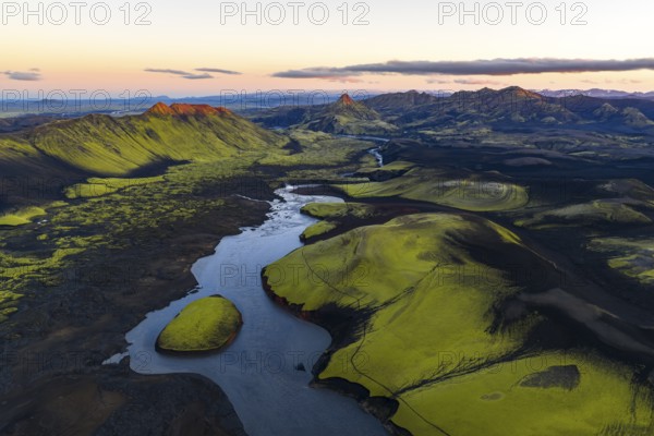 Moss-covered landscape with mountains and river in the Icelandic Highlands, Iceland