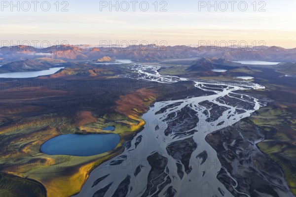Landscape with turquoise crater lake, river and mountains, Icelandic Highlands, Iceland
