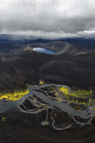 Blue crater lake in black sand desert, Icelandic Highlands, Iceland