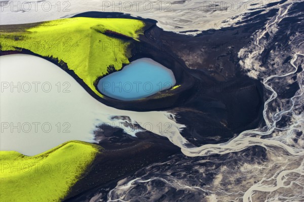 Turquoise-coloured crater lake with moss-covered crater rims in the Icelandic highlands, surrounded by glacial rivers, Iceland
