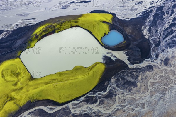 Turquoise-coloured crater lake with moss-covered crater rims in the Icelandic highlands, surrounded by glacial rivers, Iceland