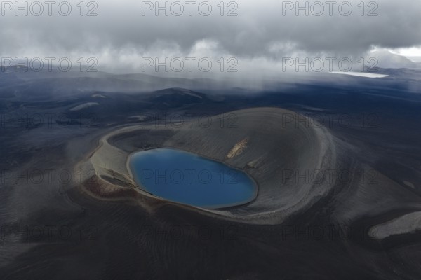 Blue crater lake in black sand desert, Icelandic Highlands, Iceland