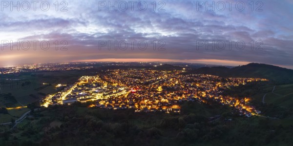 Panoramic view of an illuminated town under a cloudy evening sky, Korb im Remstal, Baden-Württemberg, Germany