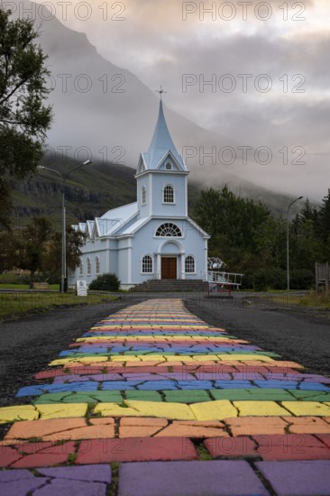 Church with rainbow pedestrian path in the town of Seyðisfjörður, East Iceland, Iceland