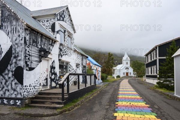 Church with rainbow pedestrian path in the town of Seyðisfjörður, East Iceland, Iceland