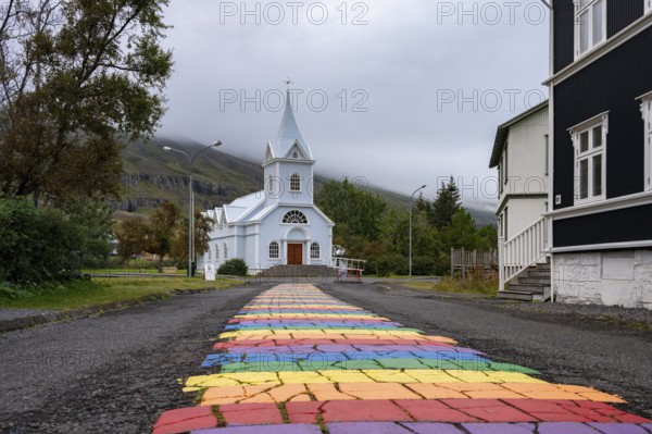 Church with rainbow pedestrian path in the town of Seyðisfjörður, East Iceland, Iceland