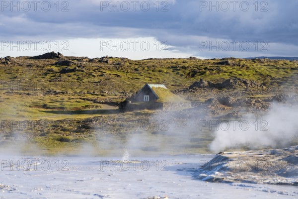 Steaming springs and traditional house at the Hveravellir geothermal area, Icelandic Highlands, Iceland