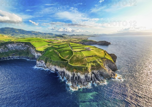 Panorama of Cape Cintrao, Cliffs, Green Hills, Fields with Pasturelands and Atlantic Ocean. Azores, Sao Miguel Island. Portugal. Aerial View
