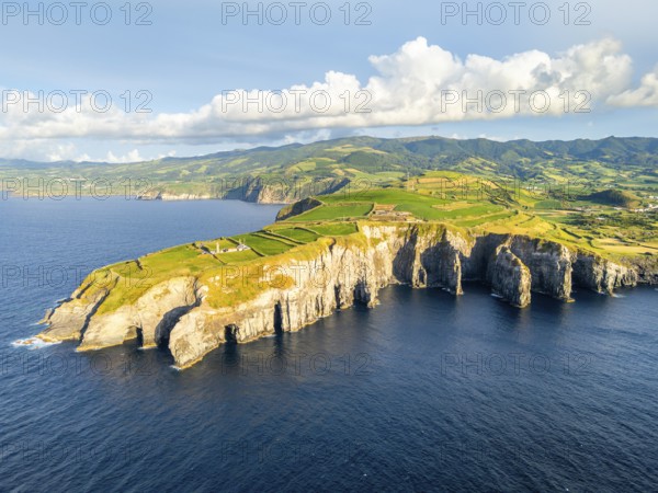 Cape Cintrao, Cliffs, Green Lush Hills, Fields, Pasturelands and Atlantic Ocean on Sunny Evening. Azores, Sao Miguel Island. Portugal. Aerial View