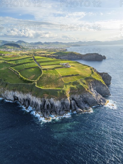 Cape Cintrao, Cliffs, Green Hills, Fields with Pasturelands and Atlantic Ocean. Azores, Sao Miguel Island. Portugal. Aerial View