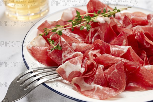 Plate with sliced cured meat, pork neck, prosciutto coppa, Italian delicacy