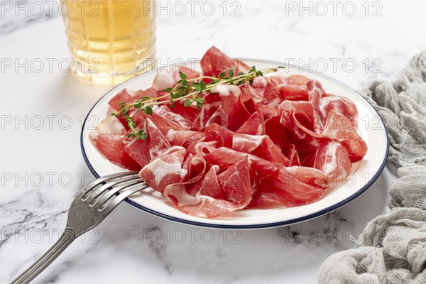 Plate with sliced cured meat, pork neck, prosciutto coppa, Italian delicacy
