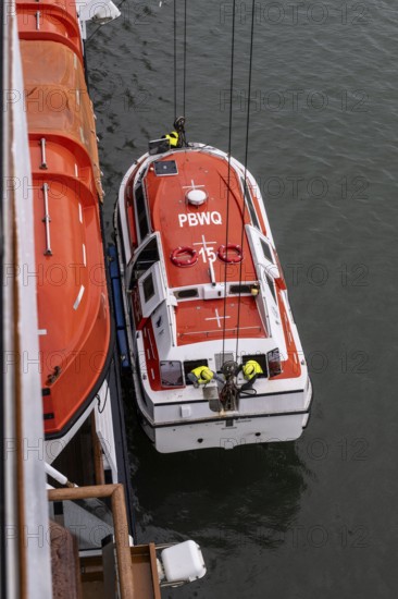 Lifeboat, cruise ship being lifted onto a cruise ship, Juneau, Alaska, USA