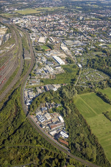 Aerial view, commercial area Östingstraße and view to the main railway station with city centre, transmitter Hamm telecommunication tower, district Pelkum, Hamm, Ruhr area, North Rhine-Westphalia, Germany, railway area, railway station, DE, Deutsche Bahn AG, Europe, commercial enterprise, commercial area, commercial area, commercial property, commercial site, commercial use, railway tracks, tracks, main station, main railway station, industrial area, industrial site, aerial view, aerial photography, aerial photography, tower, overview, bird's-eye view, overview