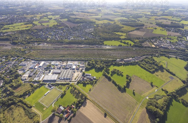 Aerial view, marshalling yard Hamm, industrial area Schieferstraße and residential area district Lohauserholz, distant view with meadows and fields, district Pelkum, Hamm, Ruhr area, North Rhine-Westphalia, Germany, railway area, DE, Deutsche Bahn AG, Europe, commercial enterprise, commercial area, commercial property, commercial location, commercial use, railway tracks, tracks, property tax, goods trains, real estate, industrial area, industrial site, aerial view, aerial photography, aerial photography, overview, bird's-eye view, residential area, housing and living, residential area, residential quality, residential neighbourhood, housing estate, residential district, birds-eyes view, overview