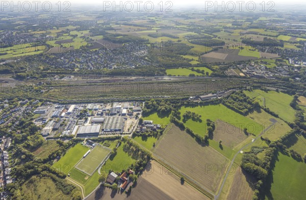 Aerial view, marshalling yard Hamm, industrial area Schieferstraße and residential area district Lohauserholz, distant view with meadows and fields, district Pelkum, Hamm, Ruhr area, North Rhine-Westphalia, Germany, railway area, DE, Deutsche Bahn AG, Europe, commercial enterprise, commercial area, commercial property, commercial location, commercial use, railway tracks, tracks, property tax, goods trains, real estate, industrial area, industrial site, aerial view, aerial photography, aerial photography, overview, bird's-eye view, residential area, housing and living, residential area, residential quality, residential neighbourhood, housing estate, residential district, birds-eyes view, overview