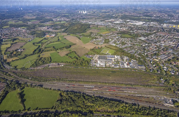 Aerial view, marshalling yard Hamm, industrial area Schieferstraße and slag heap Kissinger Höhe and slag heap Humbert, CreativRevier Hamm, former mine Ost Heinrich Robert, view to RWE Generation SE power plant Gersteinwerk with chimney and cooling towers, district Pelkum, Hamm, Ruhr area, North Rhine-Westphalia, Germany, railway area, slag heap, CreativRevier Heinrich Robert, DE, Deutsche Bahn AG, Europe, commercial enterprise, commercial area, commercial area, commercial property, commercial location, commercial use, railway tracks, tracks, property tax, goods trains, real estate, industrial area, industrial location, aerial view, aerial photography, aerial photography, overview, bird's-eye view, residential area, residential area, residential quality, residential neighbourhood, residential estate, residential district, birds-eyes view, overview