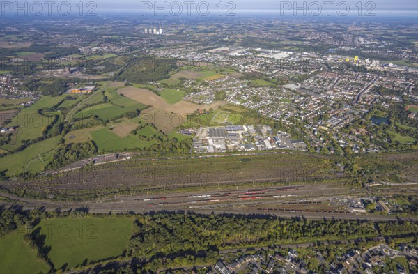 Aerial view, marshalling yard Hamm, industrial area Schieferstraße and slag heap Kissinger Höhe and slag heap Humbert, CreativRevier Hamm, former mine Ost Heinrich Robert, view to RWE Generation SE power plant Gersteinwerk with chimney and cooling towers, district Pelkum, Hamm, Ruhr area, North Rhine-Westphalia, Germany, railway area, slag heap, CreativRevier Heinrich Robert, DE, Deutsche Bahn AG, Europe, commercial enterprise, commercial area, commercial area, commercial property, commercial location, commercial use, railway tracks, tracks, property tax, goods trains, real estate, industrial area, industrial location, aerial view, aerial photography, aerial photography, overview, bird's-eye view, residential area, residential area, residential quality, residential neighbourhood, residential estate, residential district, birds-eyes view, overview