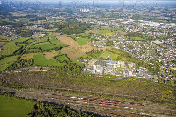 Aerial view, marshalling yard Hamm, industrial area Schieferstraße and slag heap Kissinger Höhe and slag heap Humbert, CreativRevier Hamm, former mine Ost Heinrich Robert, view to RWE Generation SE power plant Gersteinwerk with chimney and cooling towers, district Pelkum, Hamm, Ruhr area, North Rhine-Westphalia, Germany, railway area, slag heap, CreativRevier Heinrich Robert, DE, Deutsche Bahn AG, Europe, commercial enterprise, commercial area, commercial area, commercial property, commercial location, commercial use, railway tracks, tracks, property tax, goods trains, real estate, industrial area, industrial location, aerial view, aerial photography, aerial photography, overview, bird's-eye view, residential area, residential area, residential quality, residential neighbourhood, residential estate, residential district, birds-eyes view, overview