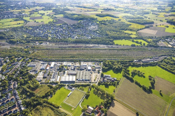 Aerial view, marshalling yard Hamm, industrial area Schieferstraße and residential area district Lohauserholz, distant view with meadows and fields, district Pelkum, Hamm, Ruhr area, North Rhine-Westphalia, Germany, railway area, DE, Deutsche Bahn AG, Europe, commercial enterprise, commercial area, commercial property, commercial location, commercial use, railway tracks, tracks, property tax, goods trains, real estate, industrial area, industrial site, aerial view, aerial photography, aerial photography, overview, bird's-eye view, residential area, housing and living, residential area, residential quality, residential neighbourhood, housing estate, residential district, birds-eyes view, overview