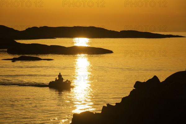 Motorboat between archipelago at sunset, archipelago landscape, Smögen, Smögenbryggan, Västra Götalands Län, Bohuslän, Sweden