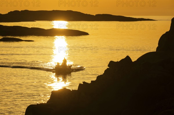 Motorboat between archipelago at sunset, archipelago landscape, Smögen, Smögenbryggan, Västra Götalands Län, Bohuslän, Sweden