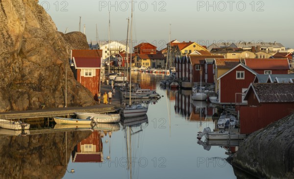 Colourful boathouses and boats in the harbour of Smögen, evening mood, Smögenbryggan, Västra Götalands Län, Bohuslän, Sweden