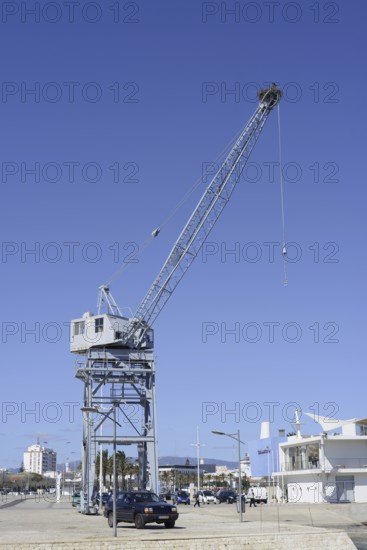 Old harbour crane with a white stork nest, Portimao, Algarve, Portugal