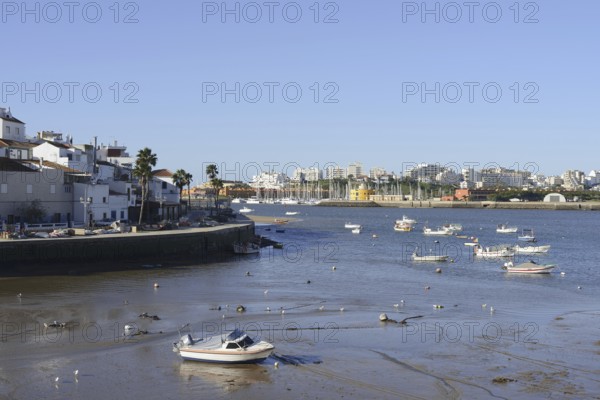 View over the mouth of the river Arade with fishing boats to Portimao, Ferragudo, Algarve, Portugal
