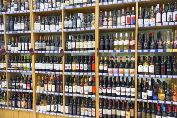 A large shelf filled with different bottles of wine in a shop, Gntunik supermarket, Aragazotn province, Armenia