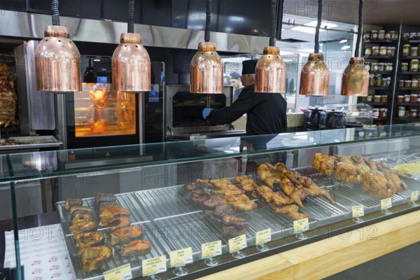 Various meats are prepared on the grill under copper lamps, Gntunik supermarket, Aragazotn province, Armenia