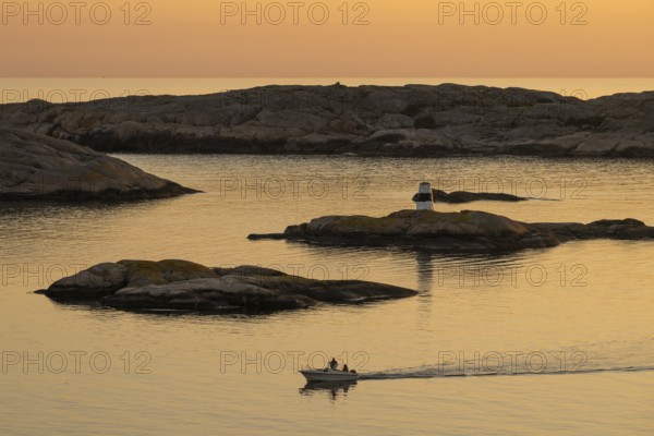 Motorboat in archipelago at sunset, Smögen, Smögenbryggan, Västra Götalands Län, Bohuslän, Sweden
