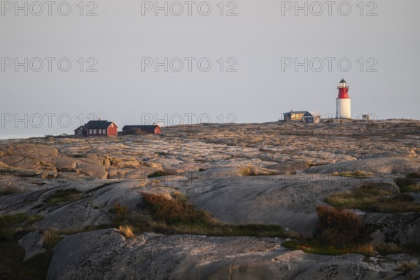 Lighthouse and houses in stony landscape at sunset, archipelago, Smögen, Smögenbryggan, Västra Götalands Län, Bohuslän, Sweden