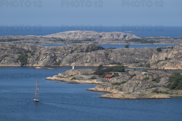 Rocky archipelago landscape with small red house by the sea, sailing ship, Fjällbacka, Bohuslän, West Sweden, Sweden