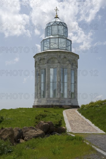 Glass church with decorative cross in a meadow under a blue sky, Garden of Eternity, Aparan, Aragazotn Province, Armenia
