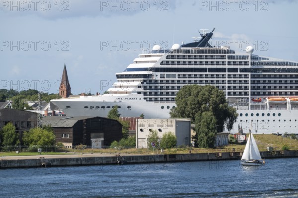 Large cruise ship MSC Poesia in the harbour, church tower in the background, Warnemünde, Rostock, Mecklenburg-Vorpommern, Germany