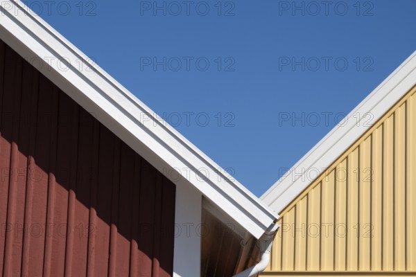 Red and yellow house gables bordering each other, blue sky, Fjällbacka, Bohuslän, West Sweden, Sweden