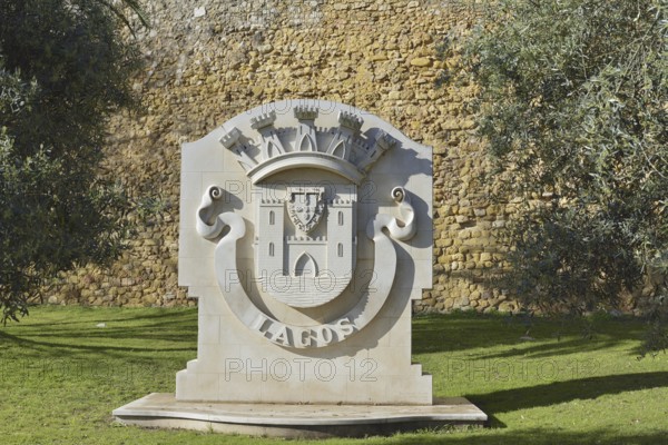 Coat of arms of the city of Lagos in front of the city wall, Lagos, Algarve, Portugal