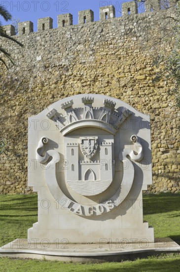 Coat of arms of the city of Lagos in front of the city wall, Lagos, Algarve, Portugal