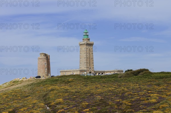 Lighthouse and landscape with flowering gorse (Ulex gallii) and heather, Cap Frehel, Cote d'Emeraude, Cotes-d'Armor, Brittany, France