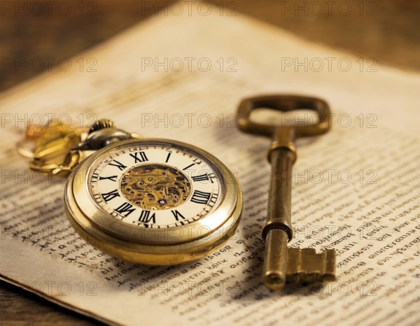 A classic golden pocket watch and ornate key resting atop an aged newspaper, symbolizing time and heritage. The scene exudes vintage charm and historical nostalgia, ideal for themes of timeless beauty, AI generated