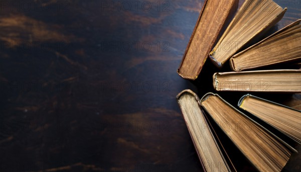 Old books arranged highlighting their historical significance. Neatly arranged representing a collection of wisdom, AI generated