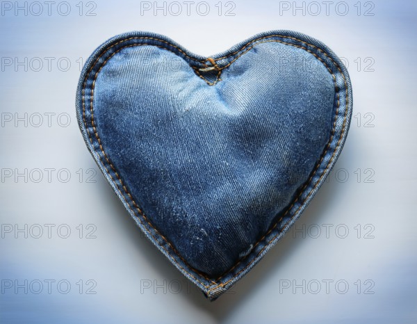 A beautiful heart-shaped denim pillow, symbolizing love and creativity, designed from repurposed blue denim. Showcasing intricate stitching and a distinctive design. Perfect for concepts of love, fashion, or upcycling handmade projects, AI generated