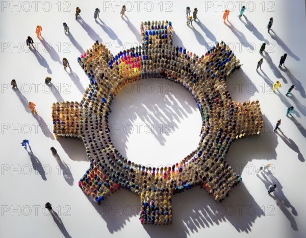 A diverse group of colorful individuals forms a gear shape, emphasizing collaboration, connection, and inclusivity highlighted by their distinct shadows on a white background, AI generated
