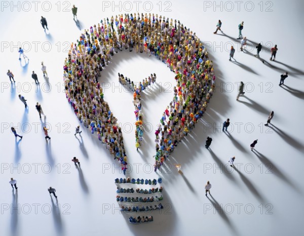 Large group of individuals assembled to form the shape of a lightbulb, symbolizing ideas, creativity, and collaboration, captured from an aerial perspective with noticeable shadows and minimalist background, AI generated