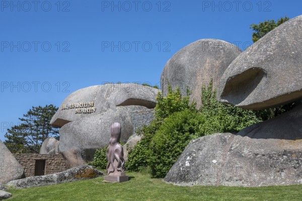 The Marin n Tregastel aquarium is spectacularly embedded in the chaos of the pink granite rocks of the Cote de Granit Rose, with the lettering on a rock and a modern octopus sculpture in the front garden, Tregastel, Cotes-d'Armor department, Brittany region, France